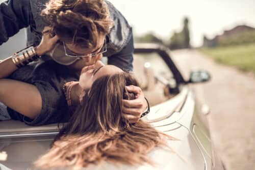 sexy latin american couple make love in the back seat of a convertible car